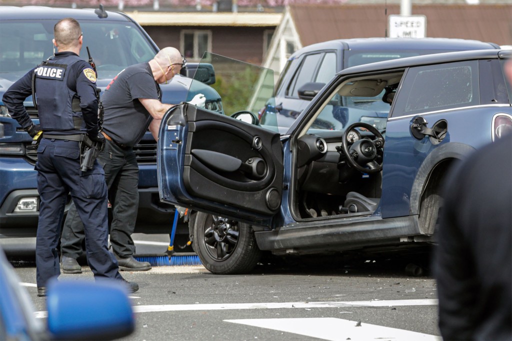 Law enforcement personnel investigate the scene of a three-vehicle crash on March 25, 2022 in Everett, Wash.