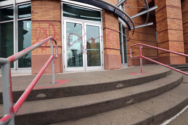 Police say a man was caught by Brockton police spray-painting graffiti across the George N. Covett Courthouse early Tuesday, Jan. 3, 2023.
