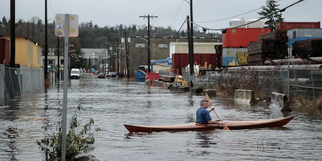 A person kayaks on South Portland Street in <a class=