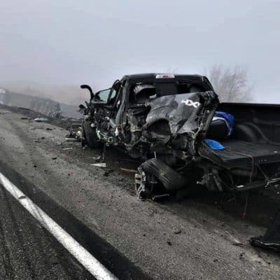 Pickup destroyed by semi truck on side of road