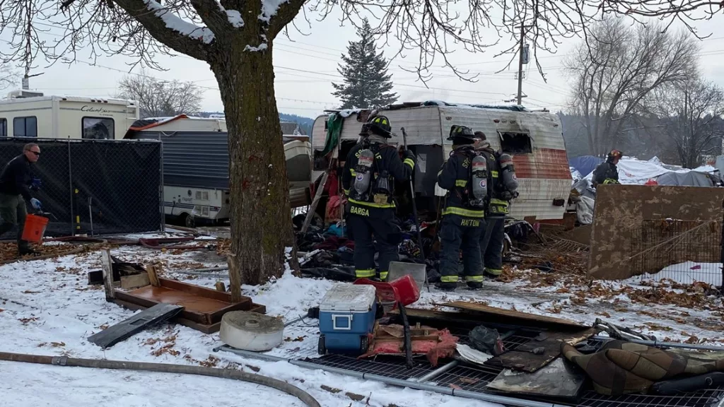 Small trailer catches fire at I-90 homeless camp, no injuries reported