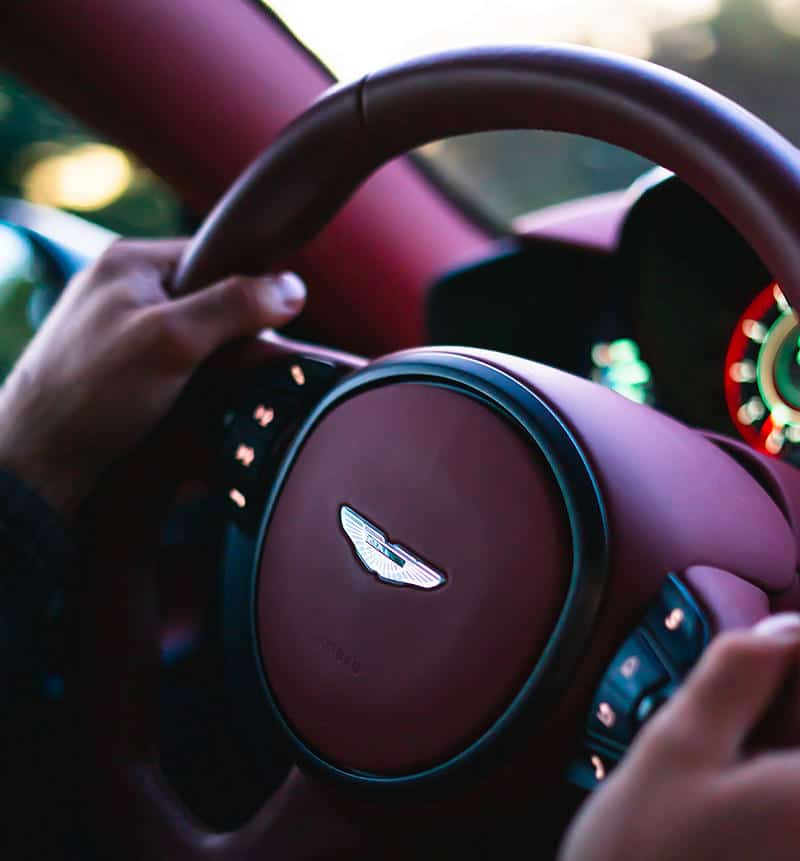 man with cap driving car